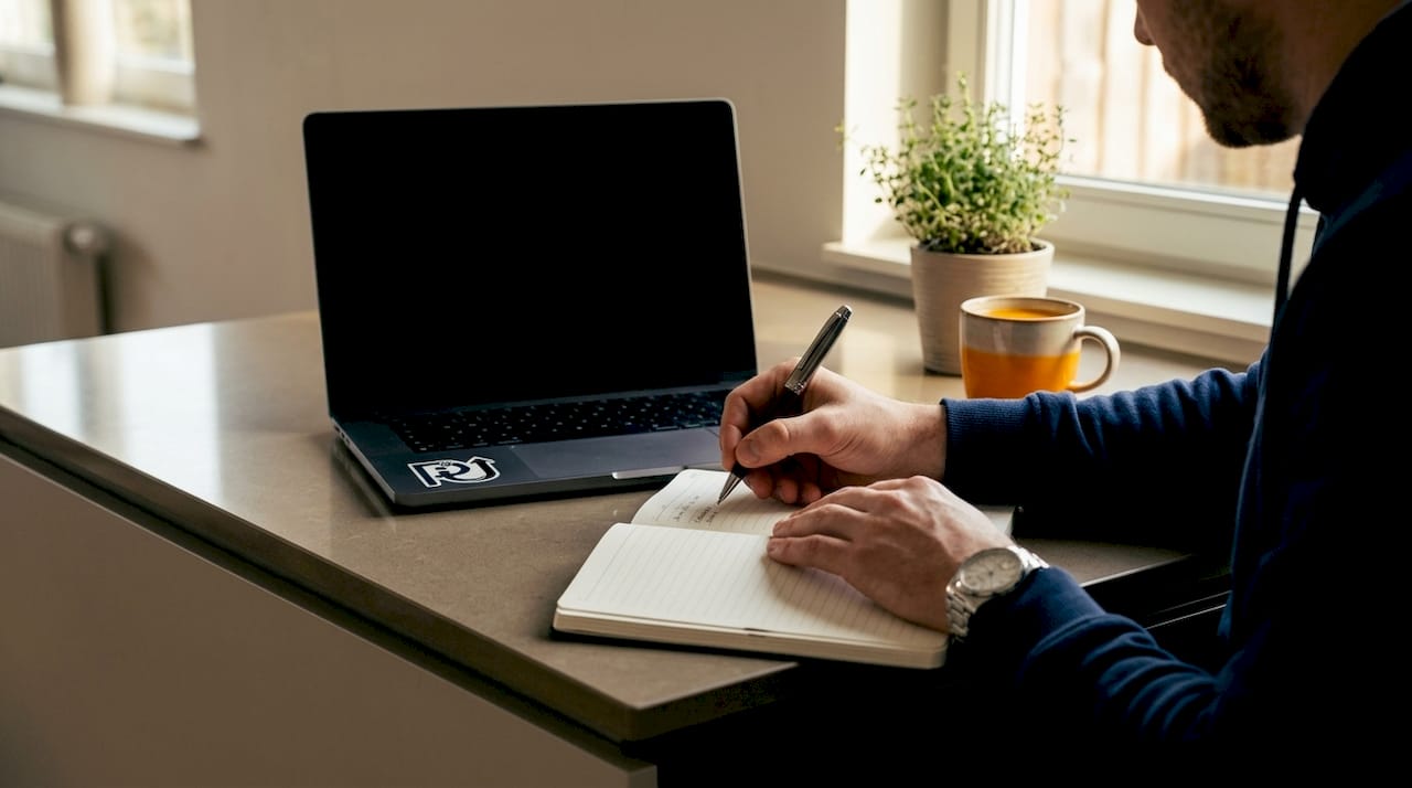 Hands typing automation ROI metrics at desk
