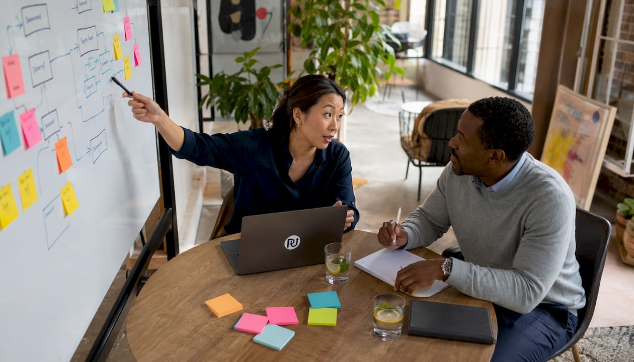 Colleagues discussing automation ROI strategy