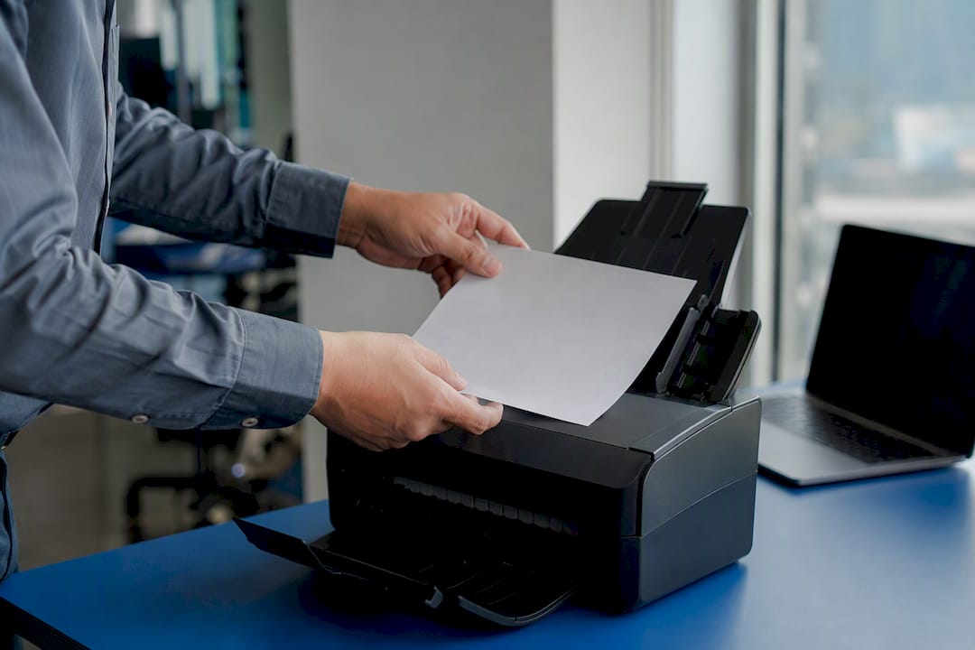 Hands placing document in scanner
